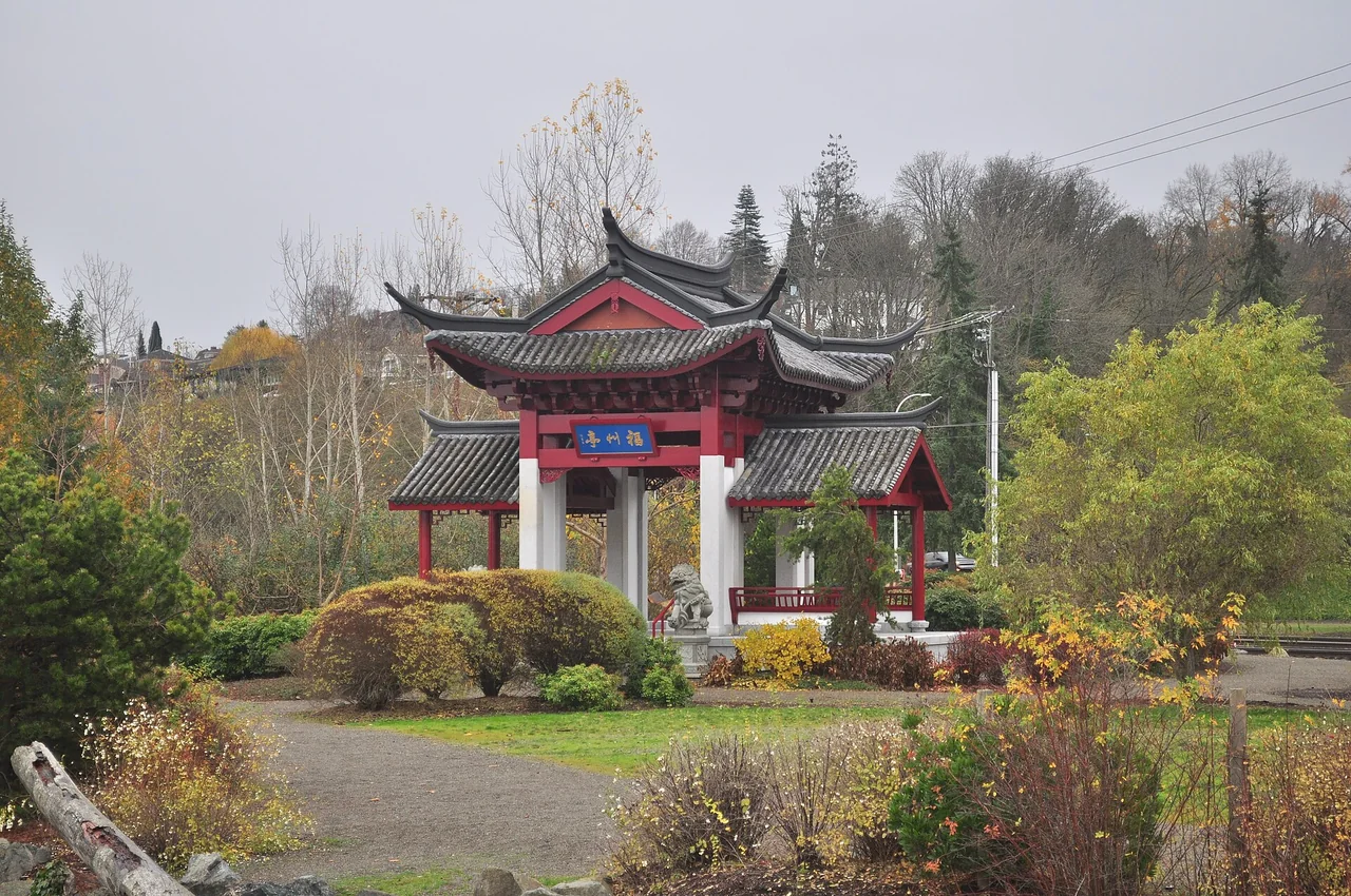 The red-pillared Fuzhou Ting pavilion sits among autumn shrubs at Chinese Reconciliation Park.