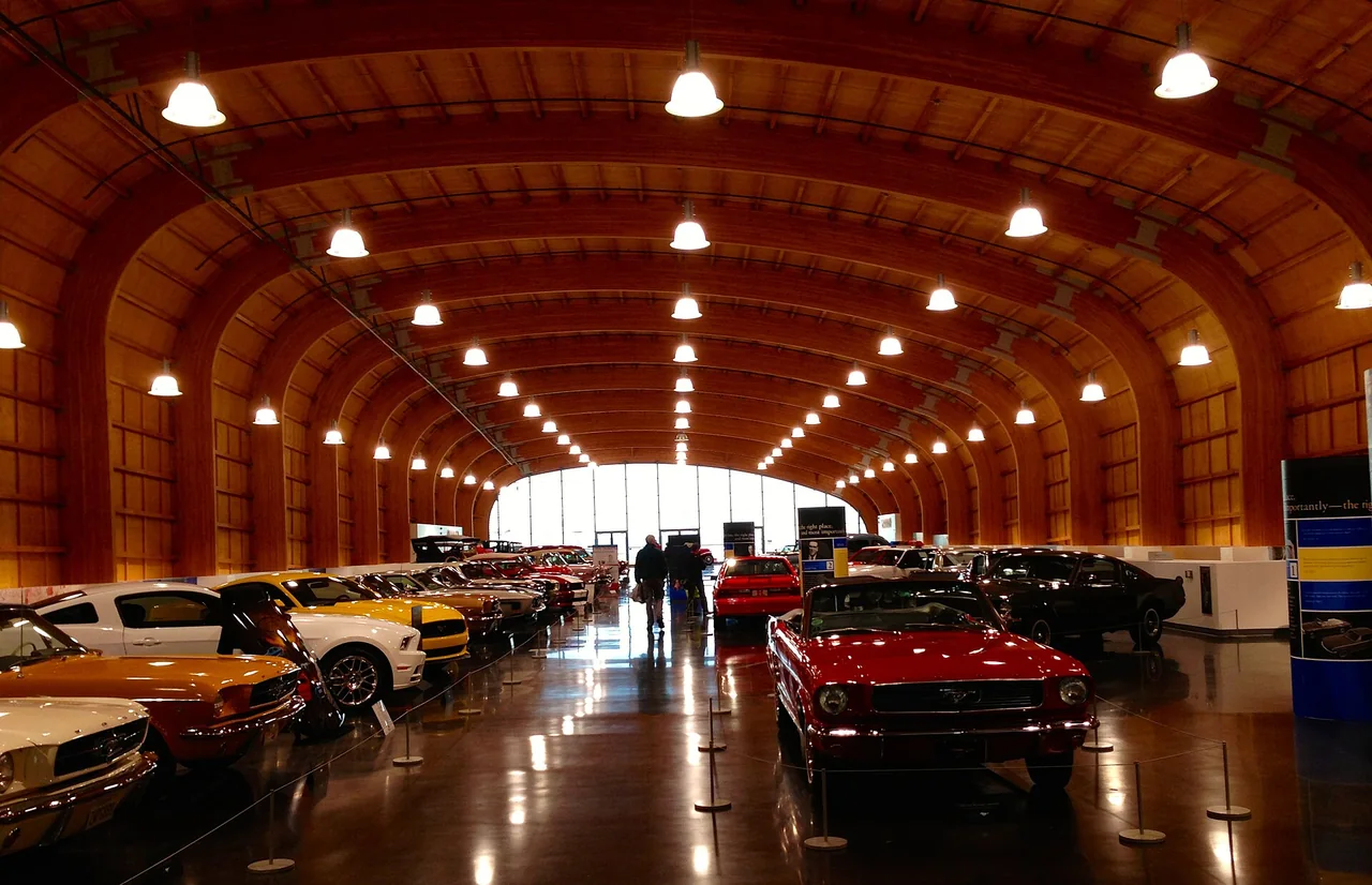 Rows of cars beneath the sweeping timber roof of America’s Car Museum.