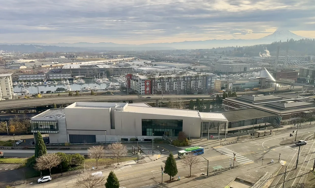Tacoma Art Museum seen from above, with its curved roof and the working waterfront beyond.